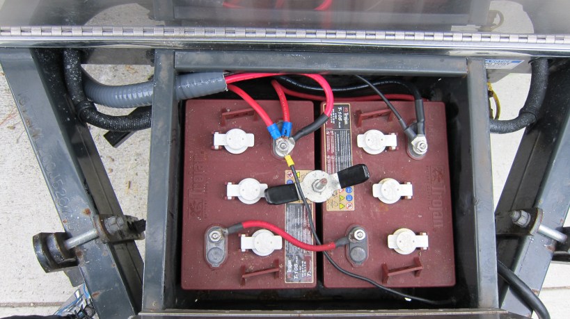 New (gray color) flexible PVC conduit routed into the battery box